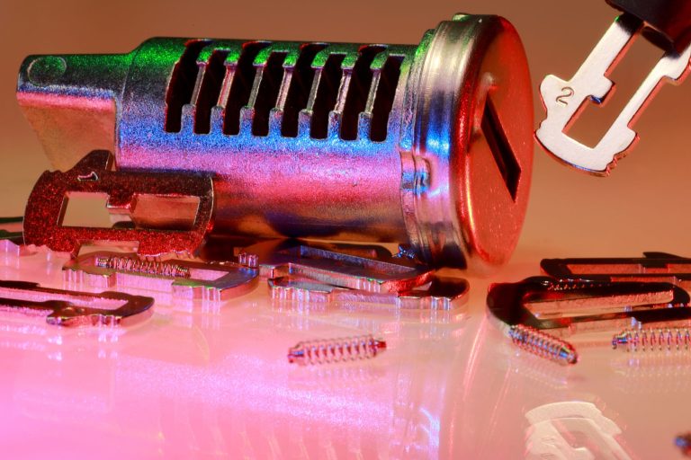 Detailed close-up of metal lock and key parts with colorful reflections, ideal for illustrating technology or security concepts.